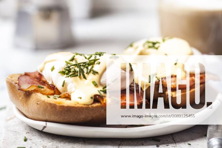 Traditional egg benedict with slices of bacon on toast, poached egg and hollandaise SBDF03826