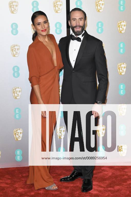 Maria Dolores Dieguez and Joseph Fiennes attend the EE British Academy Film Awards at The Royal Albert Hall in London FEBRUARY 10th 2019 PTYx19517