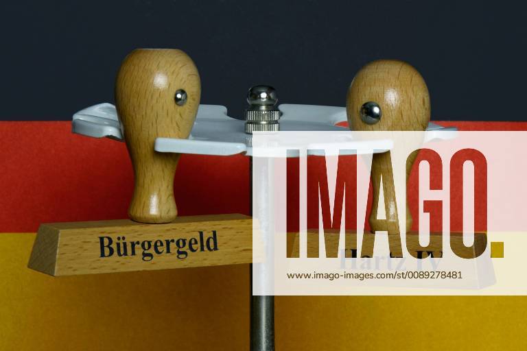 Stamp in front of a German flag Stamp in front of a German flag 08 02 2019 Borkwalde Brandenburg Stamp with the imprints Bürgergeld and Hartz IV hanging in front of a German flag