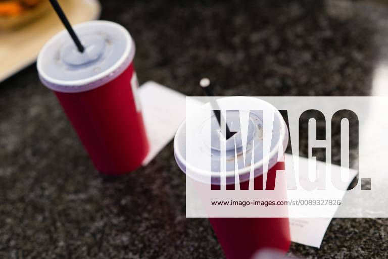 Beverage cups with drinking straw standing at the counter of a restaurant Baden Württemberg Germany Menu in a restaurant