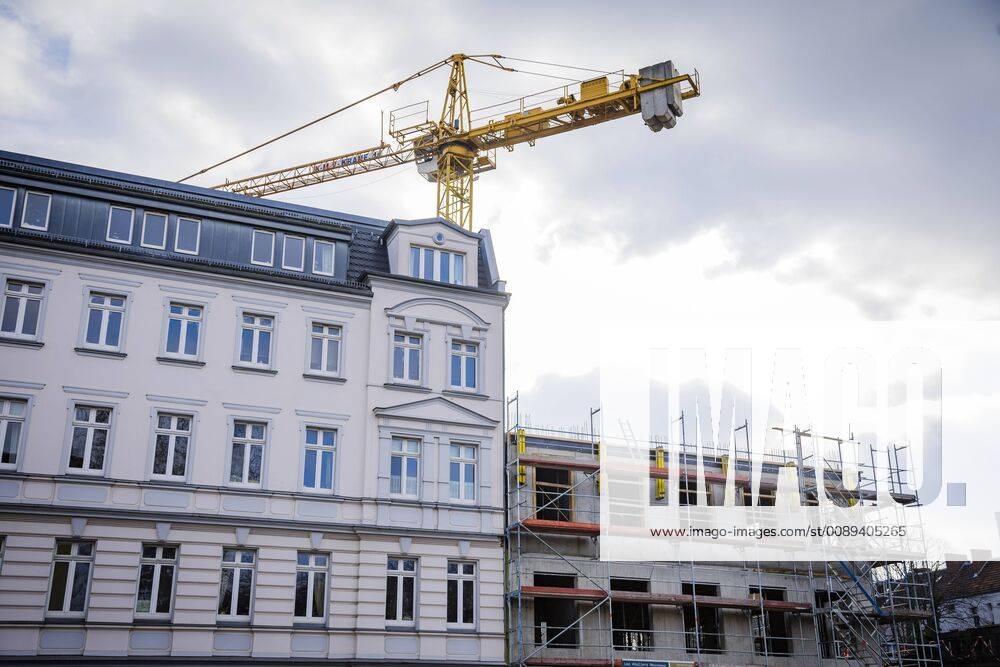 A new residential building is being built next to an old building Berlin 14 02 2019 Berlin Germany
