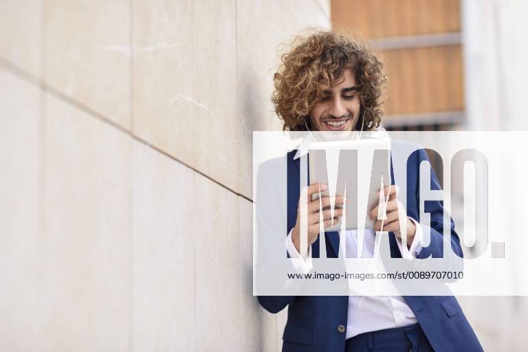 Portrait of young businessman using digital tablet outdoors model released Symbolfoto JSMF00671