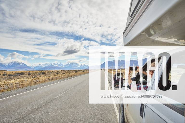 Argentina, Patagonia, El Chalten, woman taking cell phone picture in camper on road towards Fitz Roy model released Symbolfoto property released SSCF00300