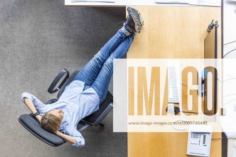 Top view of woman relaxing in chair at desk in office model released Symbolfoto property released TCF06036