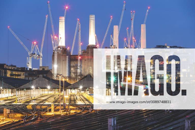 United Kingdom, England, London, view of railtracks and trains in the evening, former Battersea Power Station and cranes in the background WPEF01265