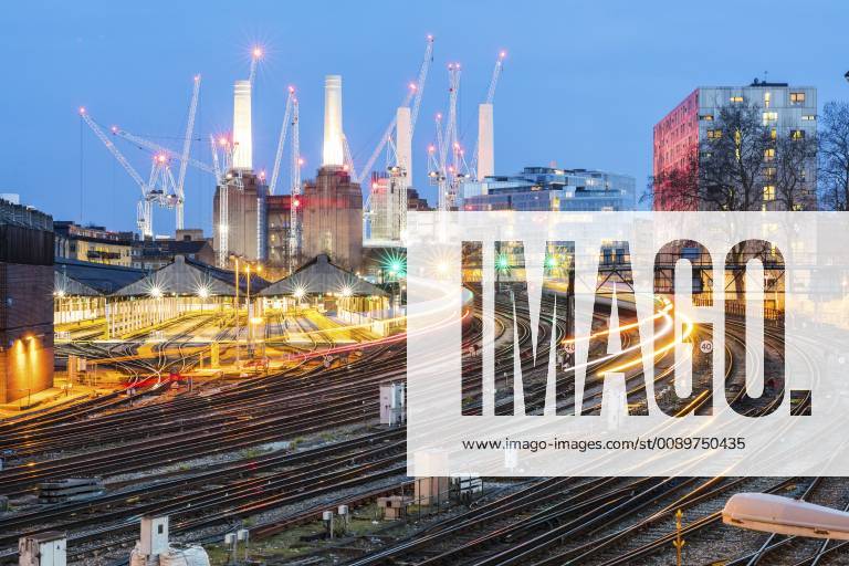 United Kingdom, England, London, view of railtracks and trains in the evening, former Battersea Power Station and cranes in the background WPEF01264