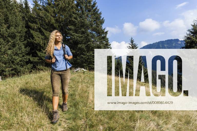 Germany, Bavaria, Oberammergau, young woman hiking on mountain meadow model released Symbolfoto property released TCF05840