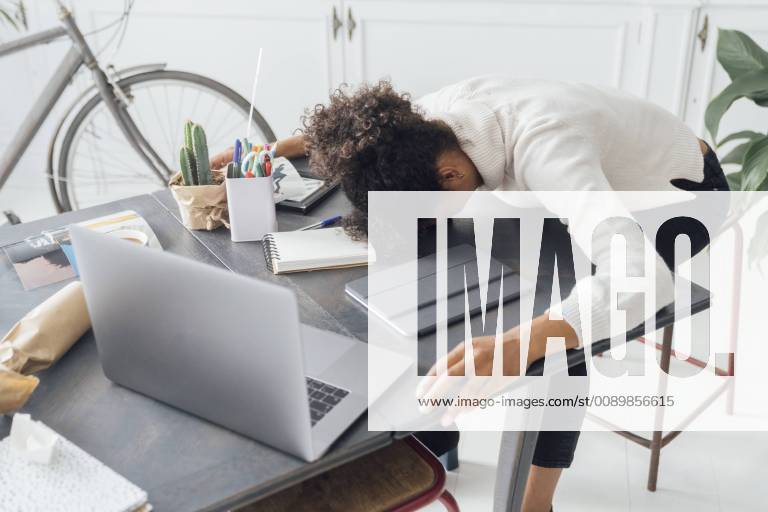Tired freelancer sleeping on her deak model released Symbolfoto property released BOYF00941