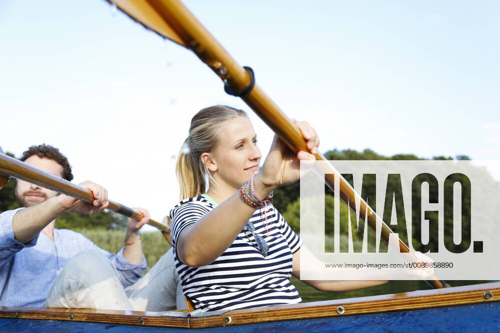 Young couple enjoying a trip in a canoe on a lake model released Symbolfoto FKF02830