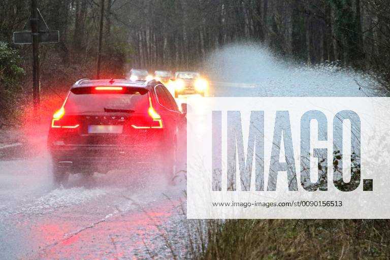 Dangerous road conditions during heavy rain The water from a road flooded after heavy rain is torn into the air by the cars and causes many drivers to be terrified Essen Nordrhein Westfalen Germany Deutschland Überruhr