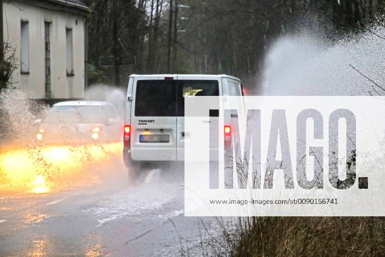 Dangerous road conditions during heavy rain The water from a road flooded after heavy rain is torn into the air by the cars and causes many drivers to be terrified Essen Nordrhein Westfalen Germany Deutschland Überruhr