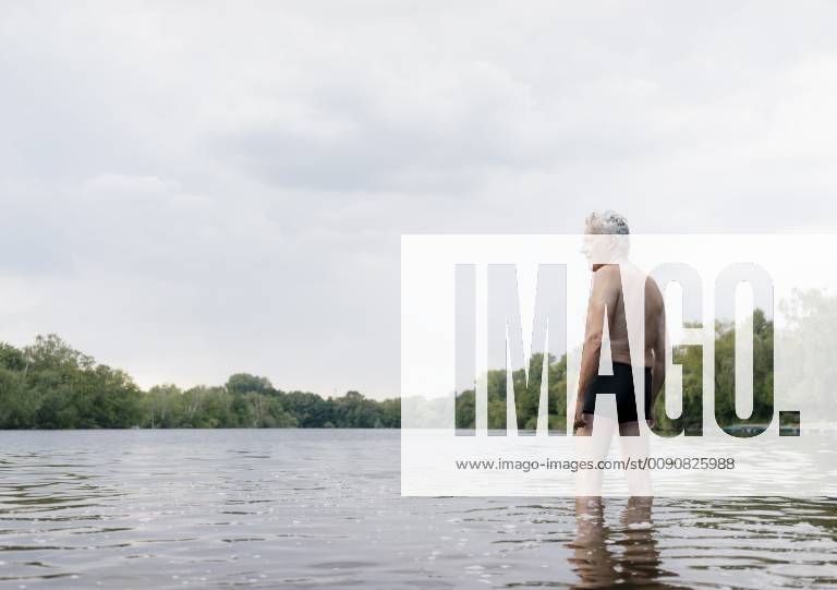 Senior man standing in a lake model released Symbolfoto GUSF01790