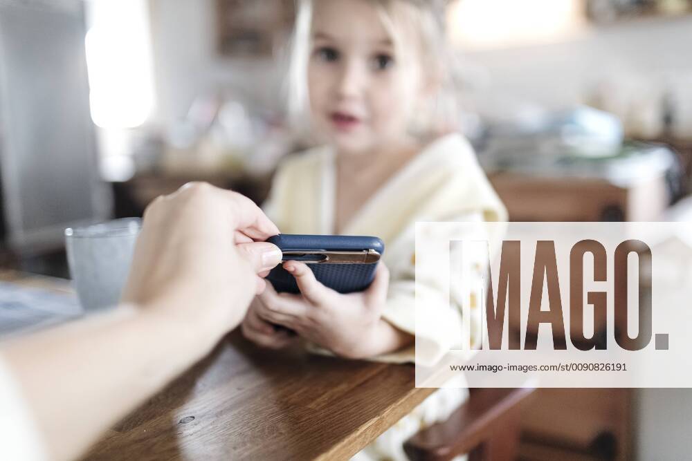 Mother s hand taking away smartphone, close-up model released Symbolfoto property released KMKF00717