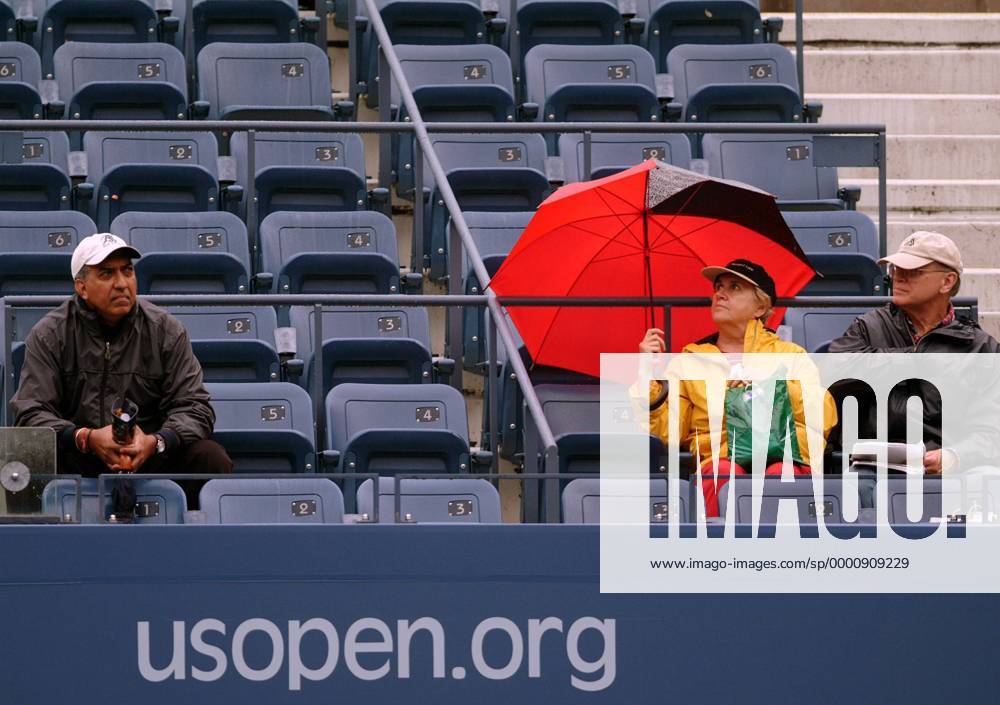 Wahre Tennisfans trotzen dem Regenwetter bei den US Open Tennis Herren US Open 2003, ATP-Tour, Grand Slam, geringes, wenig, leer, Ränge, Tribüne Gruppe Flushing Meadows, Meadow, Schirm New York, schlechtes Wetter, Regenwetter Leere