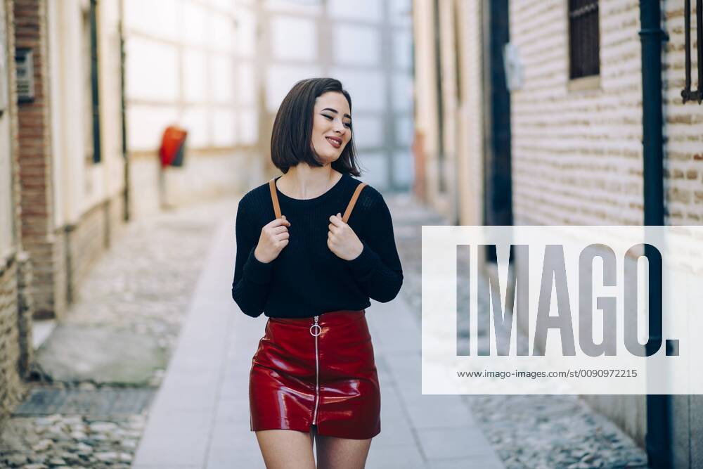 Portrait of young woman wearing red patent leather skirt with zipper model released Symbolfoto JSMF00741
