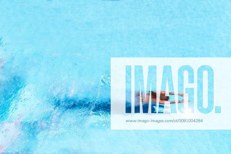 Woman diving underwater in swimming pool model released Symbolfoto SMAF01066