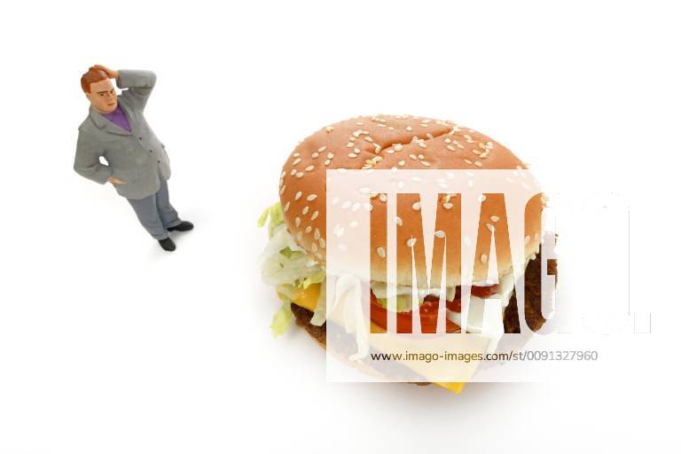 Symbol image overweight, unhealthy diet, thoughtful figure in front of Cheeseburger, Germany, Europe