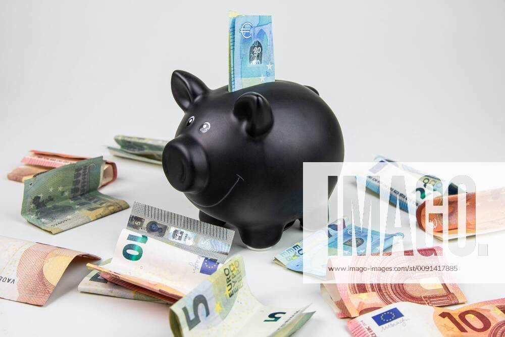 Symbol photo black piggy bank with euro banknotes and coins piggy bank and money