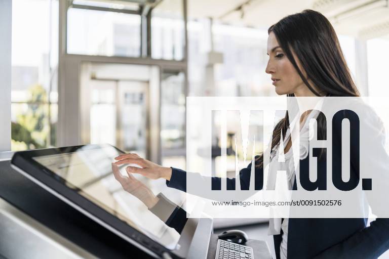 Businesswoman operating machine in a modern factory model released Symbolfoto property released DIGF06609