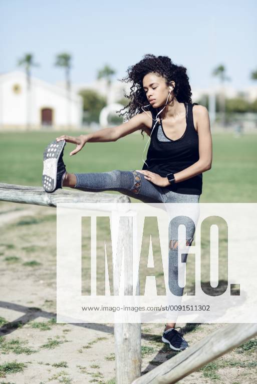Sporty young woman stretching outdoors model released Symbolfoto JSMF00835