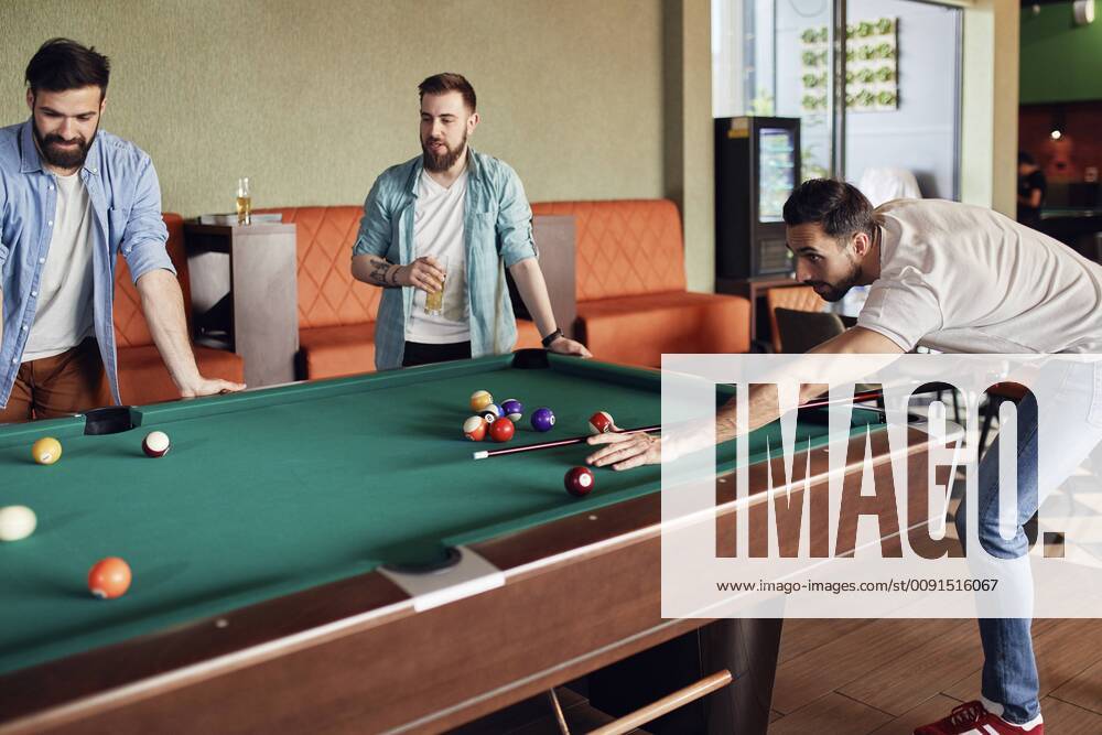 Friends playing billiards together model released Symbolfoto property released ZEDF02044