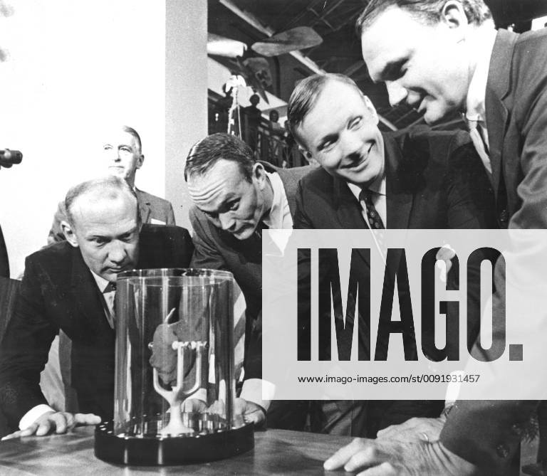 Florida, U.S. - Apollo 11 astronauts, (left to right) Edwin E. Aldrin Jr., Lunar Module pilot; Michael Collins, Command Module pilot; and Neil A. Armstrong, commander, are showing a two-pound Moon rock to Frank Taylor, director of the Smithsonian Institute in Washington D.C. The rock was picked up from the Moon s surface during the Extra Vehicular Activity (EVA) of Aldrin and Armstrong following man s first Moon landing and was was presented to the Institute for display in the Art and Industries Building. The Apollo 11 mission, launched from the Kennedy Space Center, Florida via the Marshall Space Flight Center (MSFC) developed Saturn V launch vehicle on July 16, 1969 and safely returned to Earth on July 24, 1969. With the success of Apollo 11, the national objective to land men on the Moon and return them safely to Earth - ZUMAz03_ 19690728_sha_z03_456