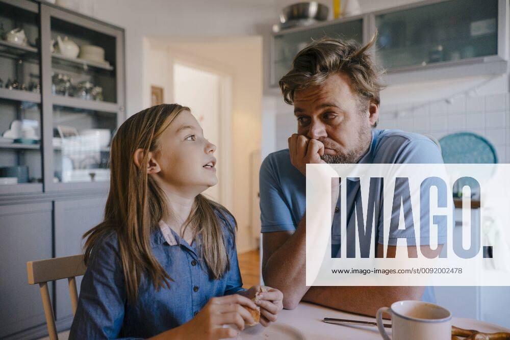Daughter talking to father in kitchen at home model released Symbolfoto property released KNSF05851