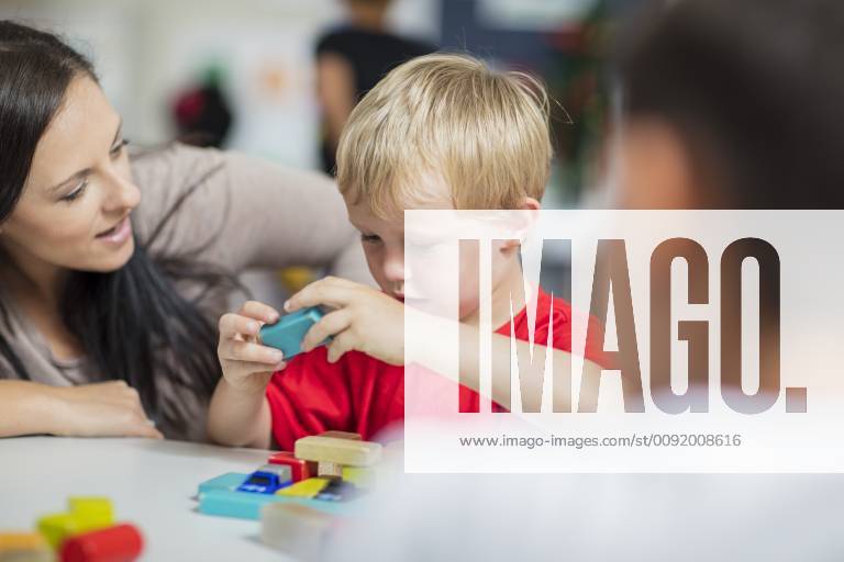 IMAGO Creative: Gesellschaft, Integration Pre-school teacher playing with child in kindergarten model released Symbolfoto property released ZEF15428