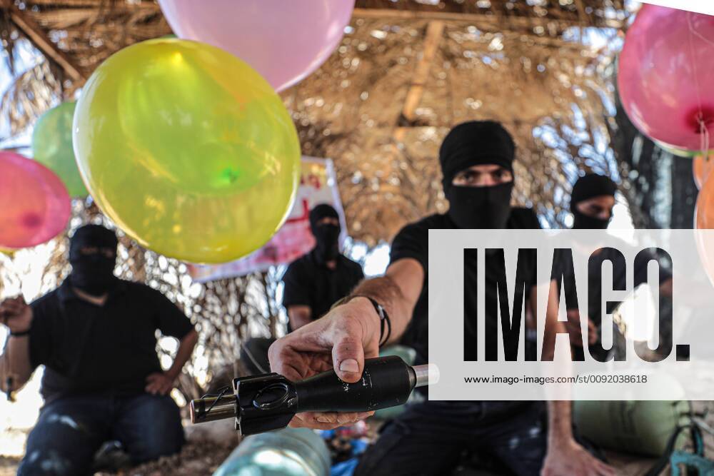 Gaza City, The Gaza Strip, Palestine - A Palestinian masked man prepares a balloon that will be attached to flammable materials and then flown toward Israel near the Israeli-Gazan border east Gaza city, Israel blocks Gaza fuel supply because of this fire balloons. Gaza City Palestine - ZUMAq100 20190627_zaa_q100_012