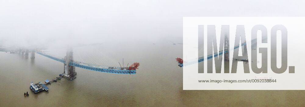 (190627) -- NANTONG, June 27, 2019 -- Aerial photo taken on June 27, 2019 shows the construction site of a Yangtze River bridge on the Shanghai-Nantong railway line in Nantong, east China s Jiangsu Province. The south main tower of the bridge was completed on Thursday, marking an important progress of the construction of the cable-stayed railway-expressway bridge. ) CHINA-JIANGSU-NANTONG-BRIDGE-CONSTRUCTION (CN) XuxCongjun