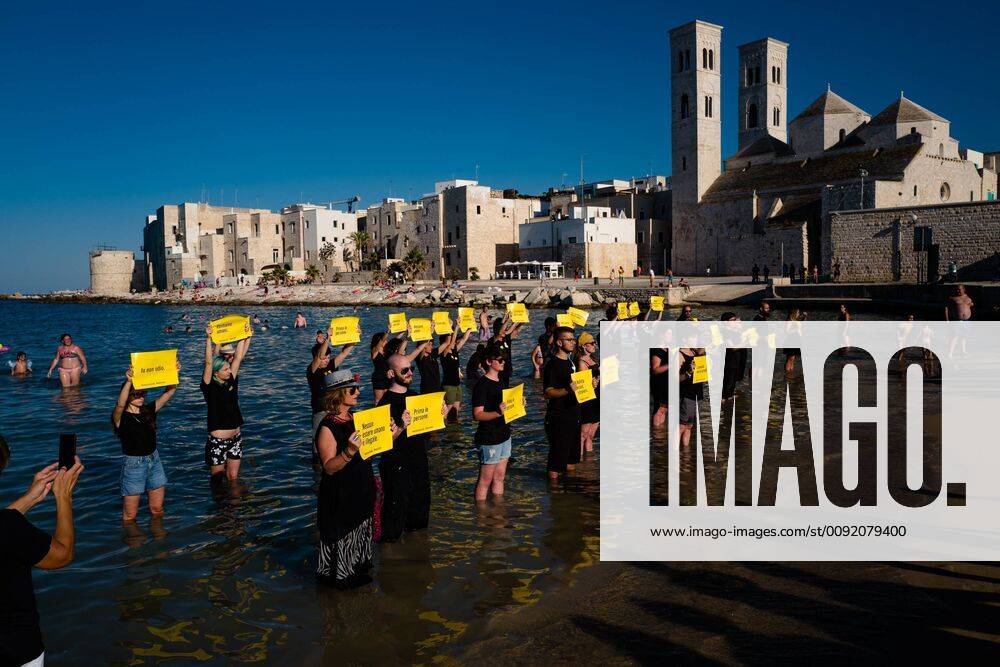 Molfetta, Italy - In Molfetta, 40 citizens belonging to different associations such as Amnesty International, Emergency, carried out a flashmob in support of Commander Carola Rackete, now under house arrest after having rescued 43 people with the Sea Watch...The event was held in Cala S. Andrea, where swimmers and passers-by attended in silence the impromptu demonstration and then turned a long applause to the activists... In Molfetta Nobody is Stranger , We remain Human , Solidarity is not a crime , Humanity does not stop , First people were instead some of the messages shown during the appointment Molfetta Italy - ZUMAn230 20190630_zaa_n230_334