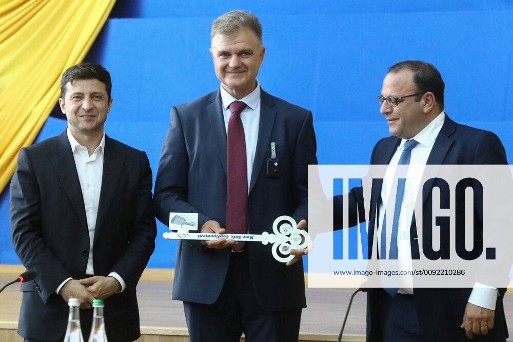 Ukraine s President Volodymyr (Vladimir) Zelensky (L), the Acting Director of the Chernobyl Nuclear Power Plant (SSE Chornobyl NPP) Serhii Kalashnyk (Sergei Kalashnik) (C), and the Chairman of the State Agency of Ukraine on Exclusion Zone Management (SAUEZM) Vytal Petruk pose with a symbolic key at a meeting of EU and Ukraine officials and representatives of international organisations marking the official handover to the Ukraine authorities of the new mobile metal structure, offically known as the New Safe Confinement, built over Reactor 4 of the Chernobyl Nuclear Power Plant; the construction of the 1.5bn euro metal shelter began in 2012; Reactor 4 is the site of the 1986 Chernobyl disaster. Pyotr Sivkov TASS TS0B2A20