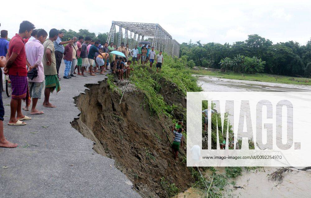 (190713) -- ASSAM, July 13, 2019 -- Villagers gather at the site of soil erosion caused by flood water at Baksa in Assam state, India, July 13, 2019. Nearly one million people have been affected by monsoon floods in Assam as monsoon floods have inundated some places in the state. (Str Xinhua) INDIA-ASSAM-FLOOD ZhangxNaijie
