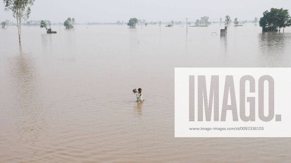 A man wades through a breach in the Ghaggar River which widened in Pulad village, on July 19, 2019 in Sangrur, India. The Ghaggar river on Thursday crossed the danger mark in Sangrur district and caused a 70-foot-long breach on its banks at Phulad village of Moonak sub-division, forcing the administration to call in the army and the National Disaster Response Force (NDRF) to plug it. The breach, caused by rising level of water in Ghaggar due to heavy rain, developed at 6am and went up to 70 feet by the evening as the teams of the army, NDRF and the State Disaster Response Force (SDRF) failed to plug it. (Photo by Bharat Bhushan Hindustan Times ) Ghaggar River Breaches Banks In Sangrur; Army, NDRF Called In To Plug Gap