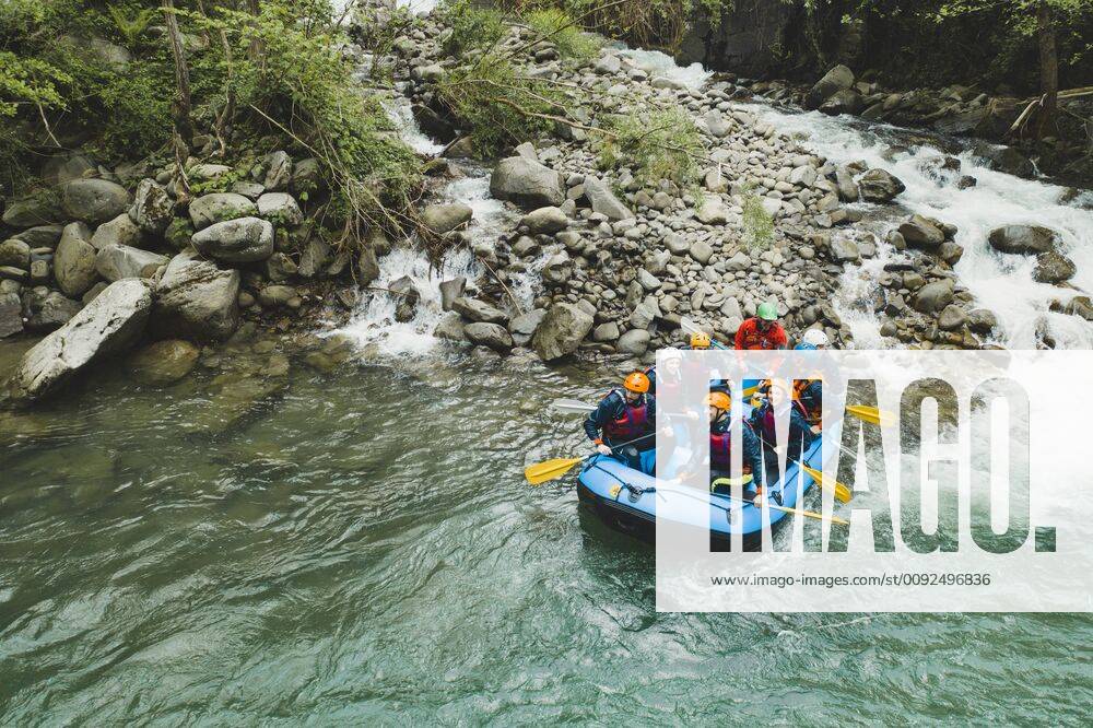 Group of people rafting in rubber dinghy on a river model released Symbolfoto FBAF00710