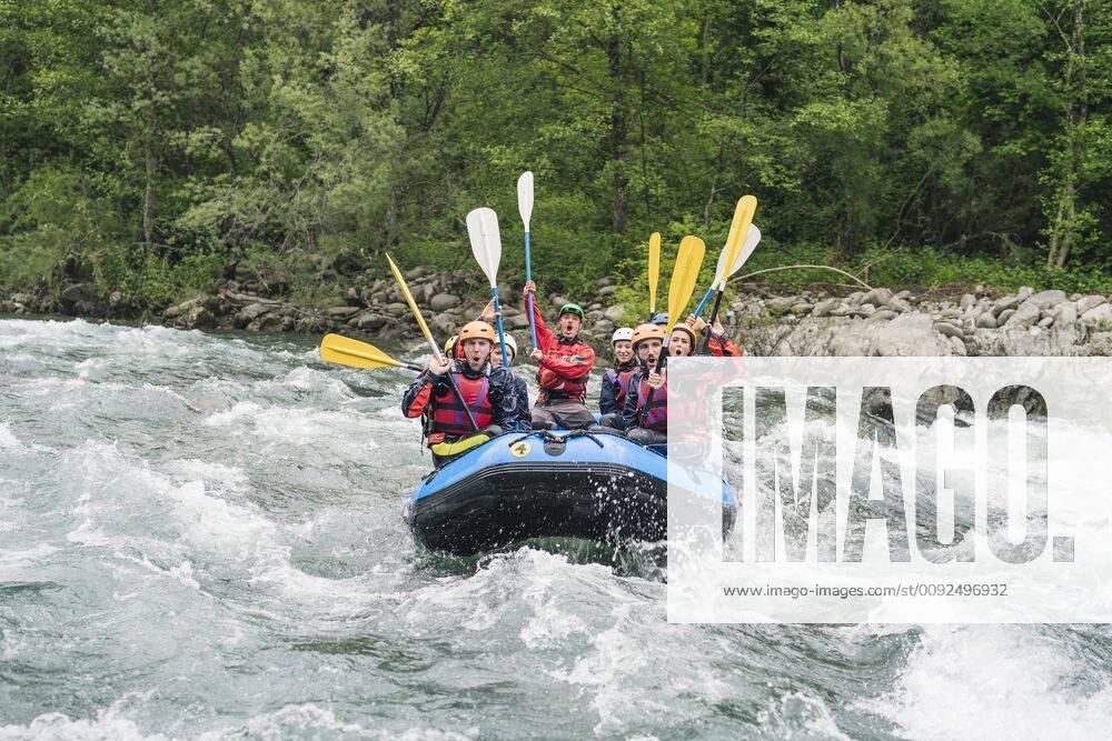 Group of people rafting in rubber dinghy on a river model released Symbolfoto FBAF00740