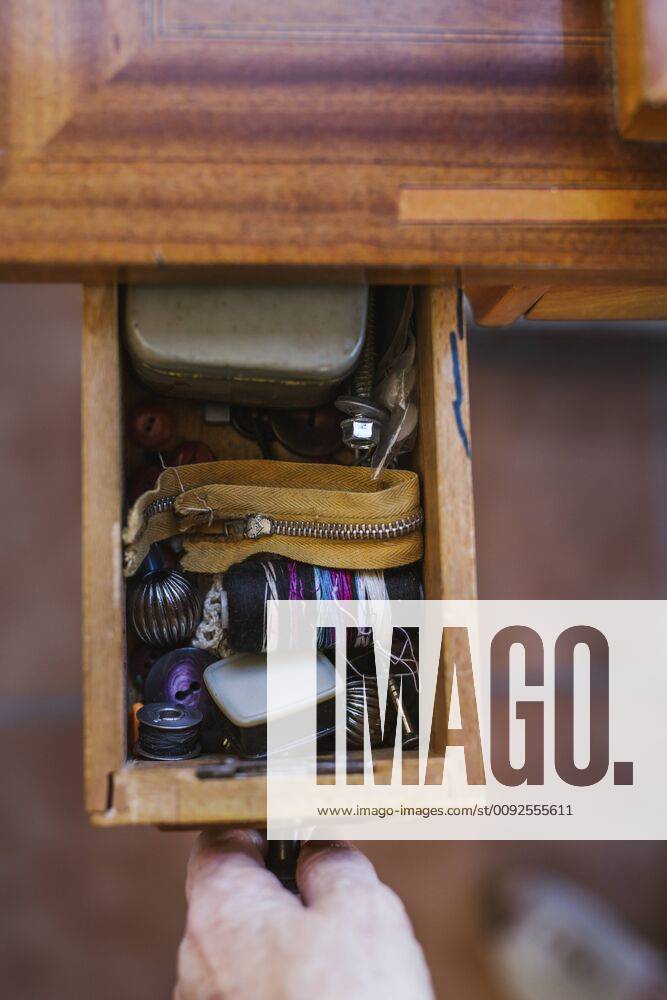 Close-up of woman opening a drawer with sewing items model released Symbolfoto property released LJF00112
