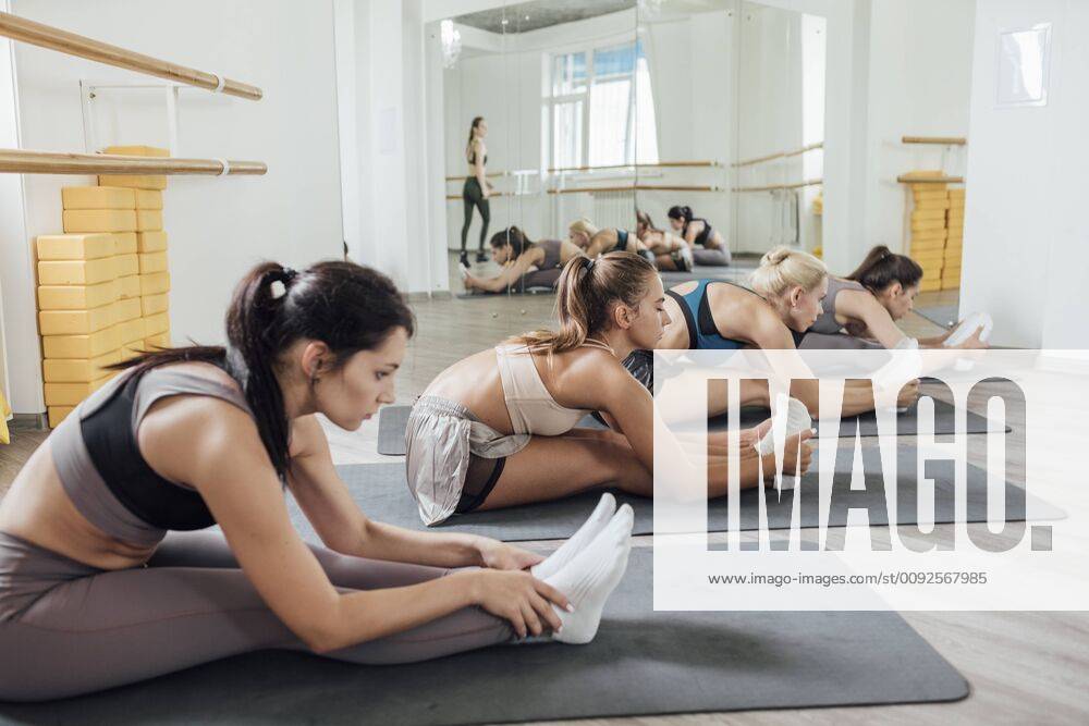 Young women doing stretching exercise in gym model released Symbolfoto property released VPIF01268