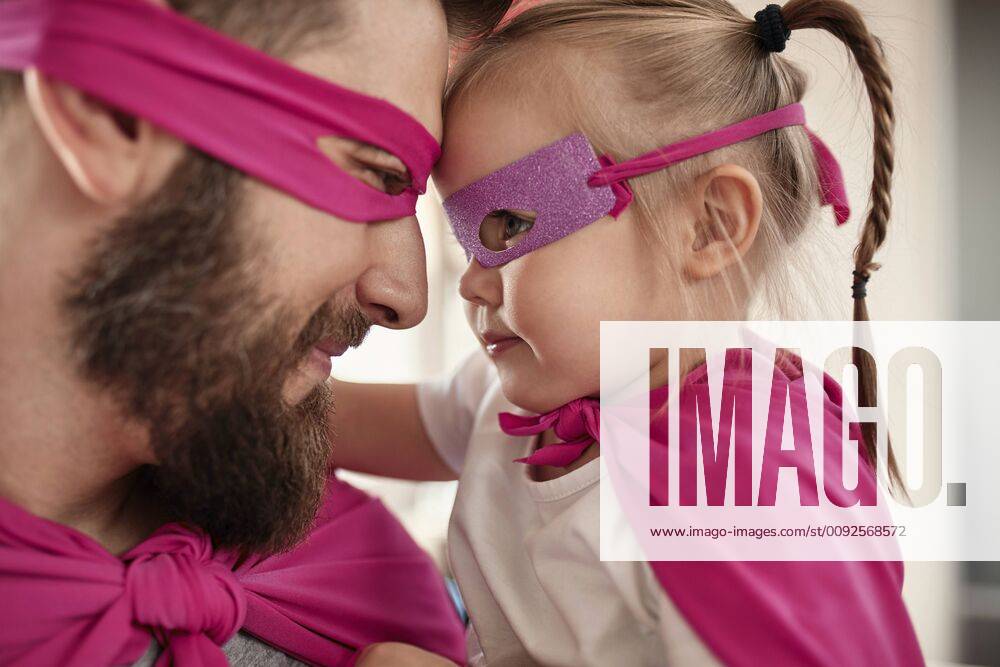Father and daughter playing super hero and superwoman model released Symbolfoto property released ZEDF02511