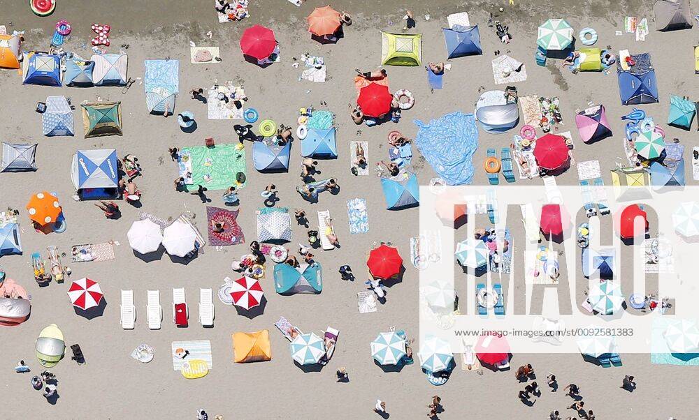 Heat wave in Japan Photo taken Aug. 4, 2019, from a Kyodo News helicopter shows parasols on Zushi Beach in Kanagawa Prefecture, near Tokyo, as people flock there for sea bathing amid the scorching summer heat.