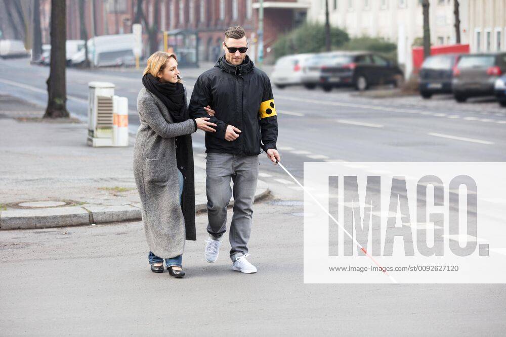Woman Assisting Blind Man On Street ,model released, Symbolfoto