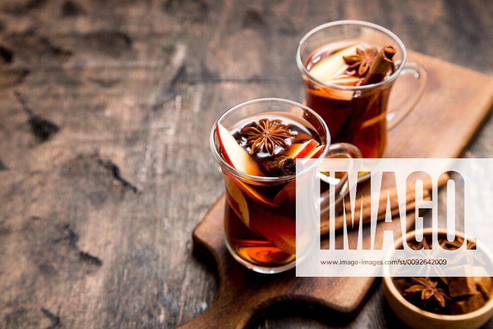 Hot spicy beverage. Hot drink (apple tea, punch) with cinnamon stick and star anise. Seasonal mulled drink