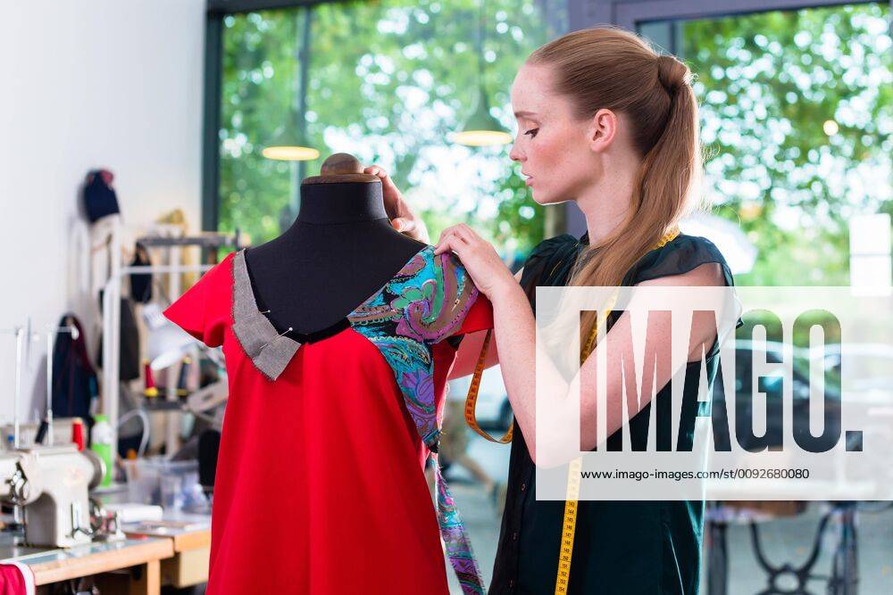 Fashion designer draping dress on mannequin ,model released, Symbolfoto