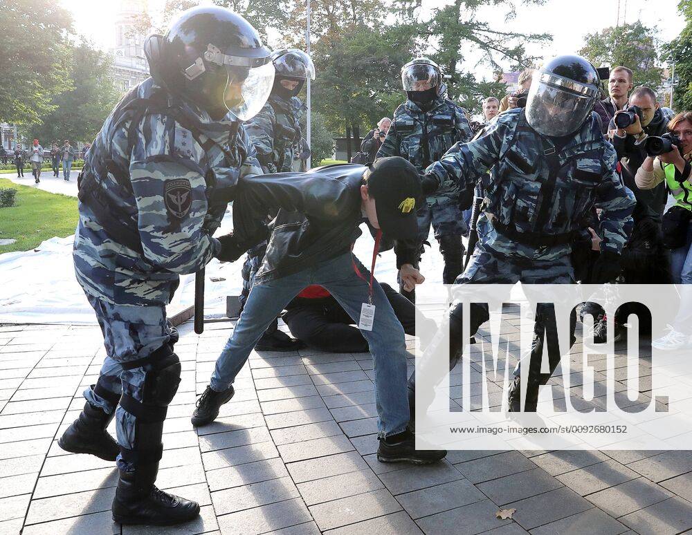 Riot police detain a young man during an unsanctioned protest in Chistoprudny Boulevard against the disqualification of opposition candidates from the forthcoming Moscow City Duma election. Sergei Savostyanov TASS TS0B603D
