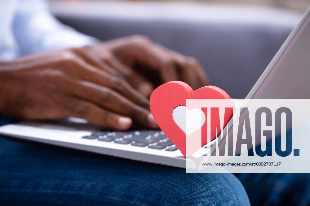 Heartshape On Keypad While Man Using Laptop ,model released, Symbolfoto