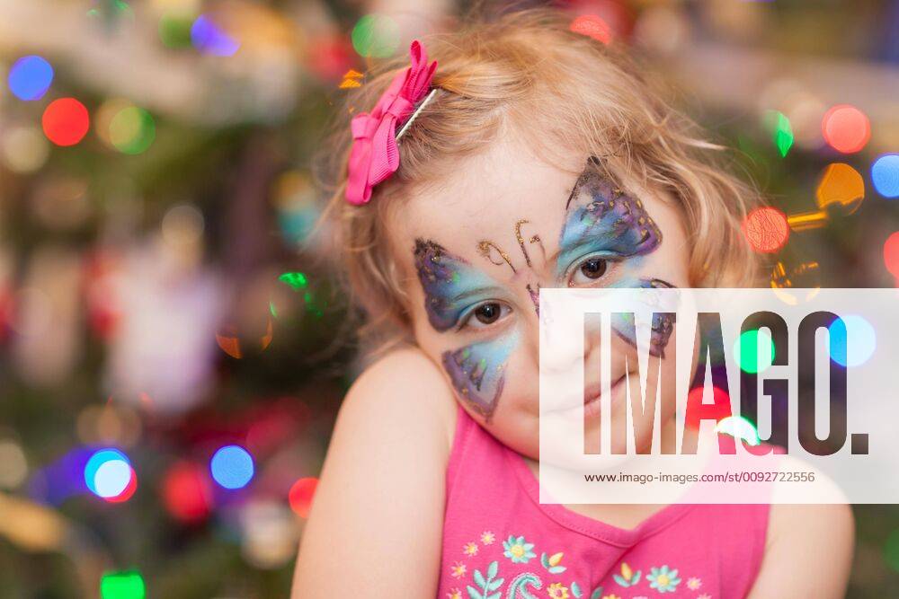 Cute girl with butterfly face paint ,model released, Symbolfoto
