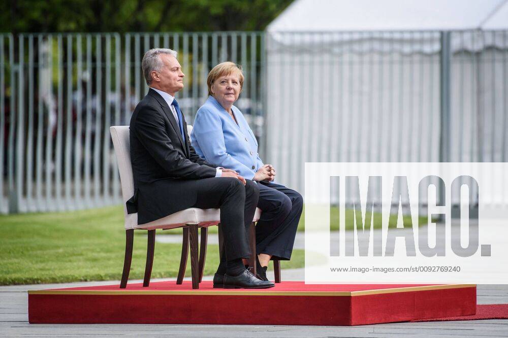Berlin, Angela Merkel meets the President of the Republic of Lithuania Gitanas Nauseda Germany, Berlin 14 08 2019 The picture shows the German Chancellor Angela Merkel CDU and the President of the Republic of Lithuania Gitanas Nauseda sitting during the reception with military honours in the courtyard of the Federal Chancellery on a chair Berlin Federal Chancellery Berlin Germany
