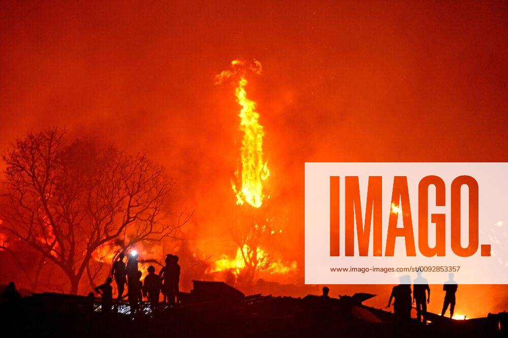 (190816) -- DHAKA, Aug. 16, 2019 (Xinhua) -- Local people gather after a fire broke out in a slum in Dhaka, Bangladesh, on Aug. 16, 2019. A devastating fire on Friday night swept through one of the largest slums in Bangladesh capital Dhaka, leaving tens of thousands of people homeless. (Str Xinhua) BANGLADESH-DHAKA-SLUM-FIRE