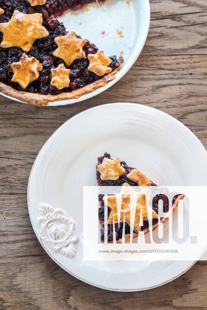 Portion of mince pie on the wooden background