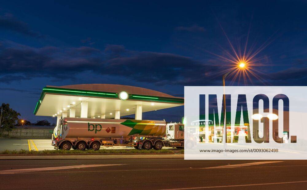 Tanker truck in front of petrol station with street lighting at night, Otago, South Island, New Zealand, Oceania